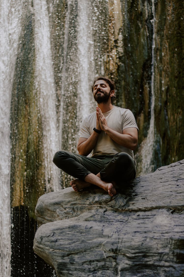 Man Meditation Near Waterfall