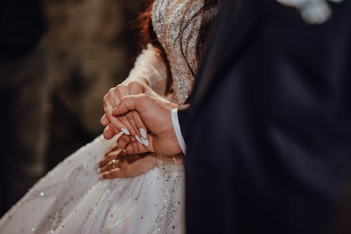 Close-up of Bride and Groom Holding Hands 