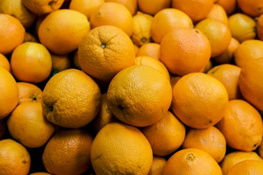 Close-up of fresh, vibrant oranges in abundance, perfect for healthy eating.