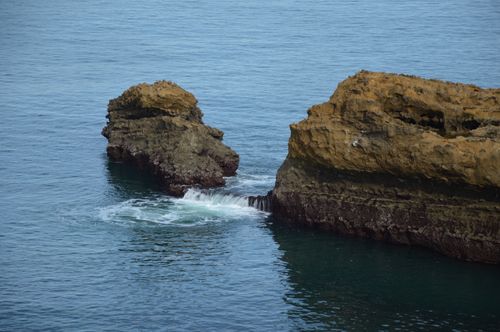 Free Natural rock formations eroded by the sea along a serene coastal edge. Stock Photo