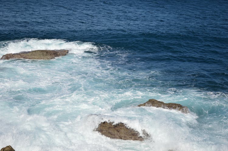Waves Splashing On Rocks In Sea