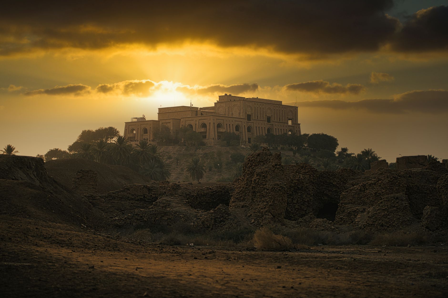 Dramatic sunset over Saddam Hussein's Palace in Babylon, captured with moody lighting.