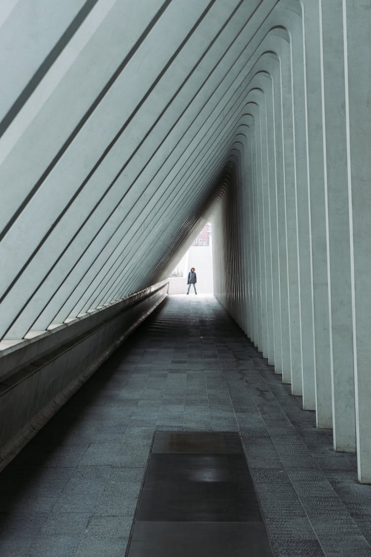 Person Standing At The End Of A Hallway