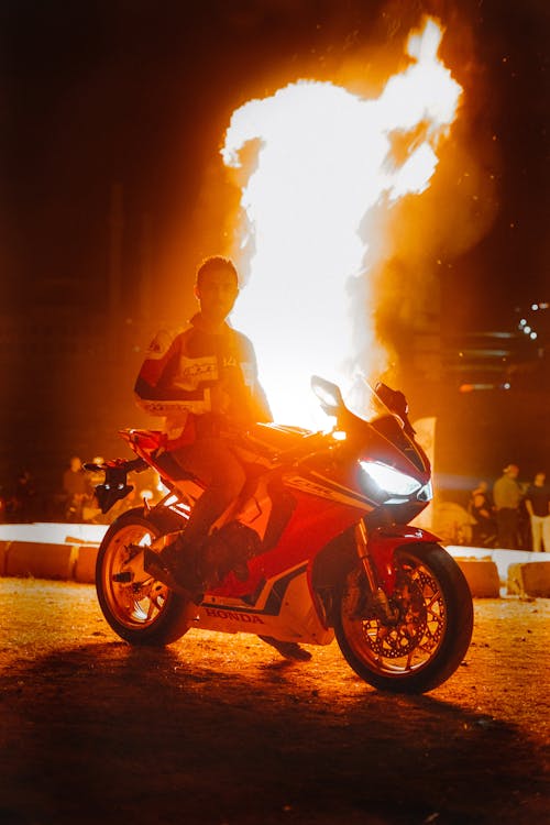 Man on Motorcycle with Flame behind