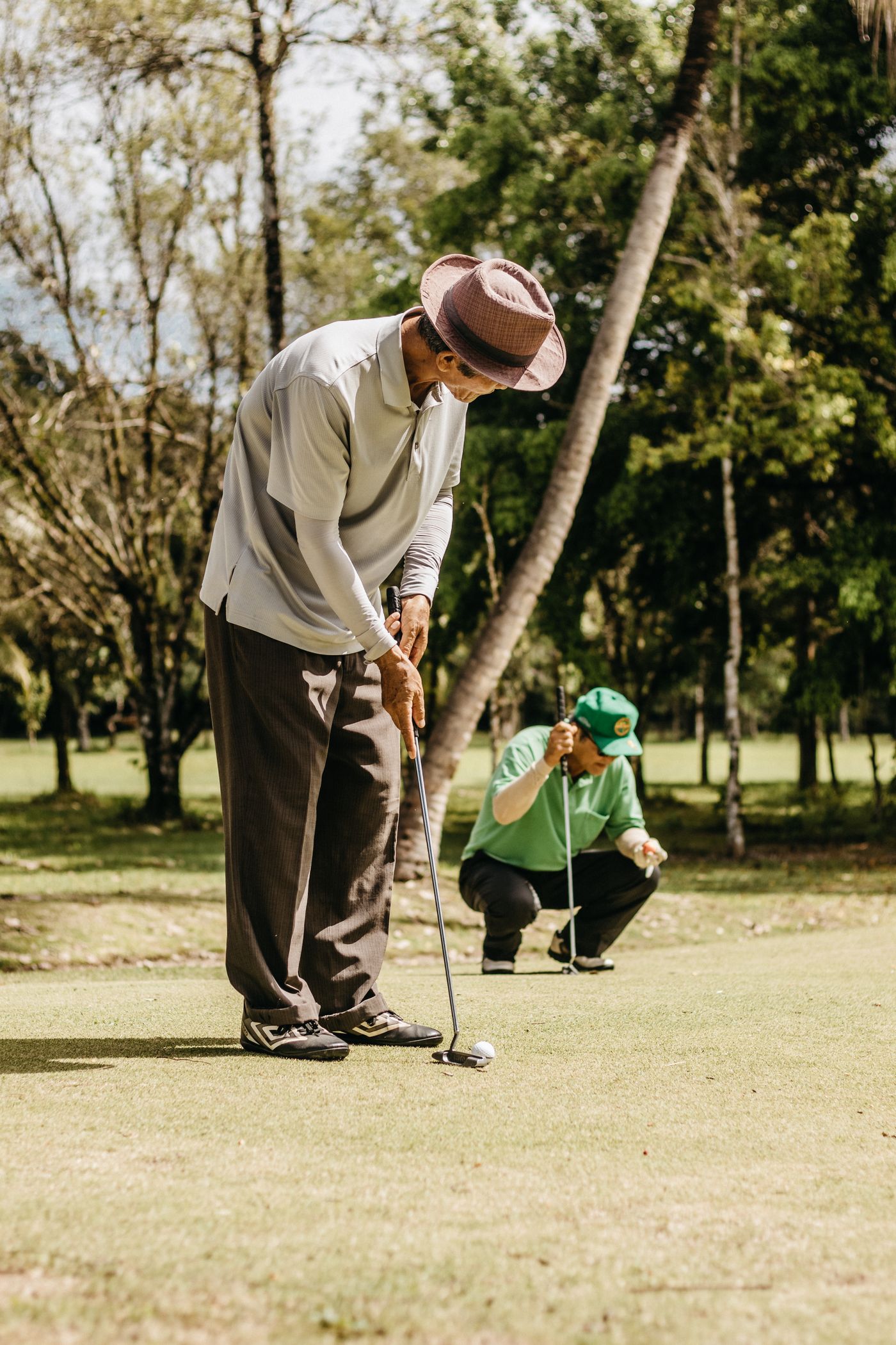 Golfers playing together on a putting green