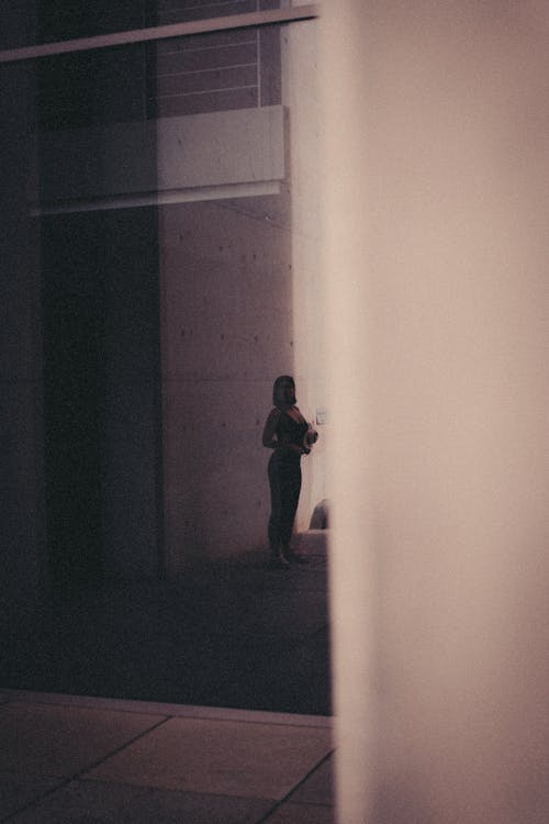 Woman Standing on Sidewalk