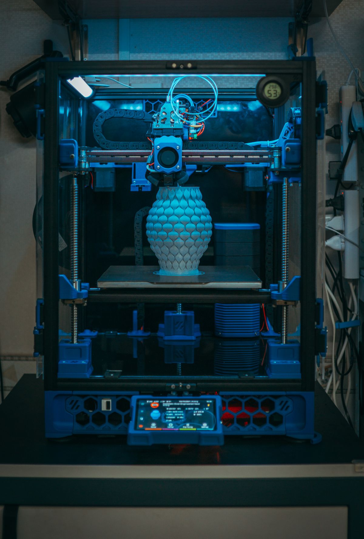 A 3D printer crafting a detailed vase, demonstrating the precision of additive manufacturing