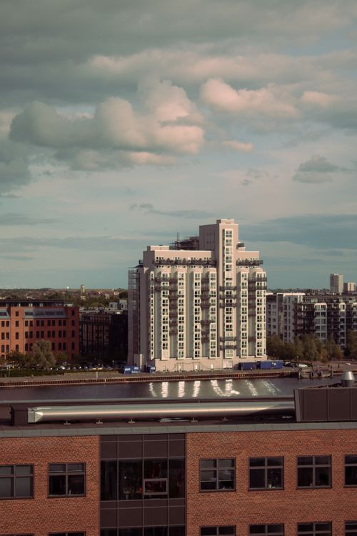 Free A contemporary building in an urban cityscape under a cloudy sky. Stock Photo