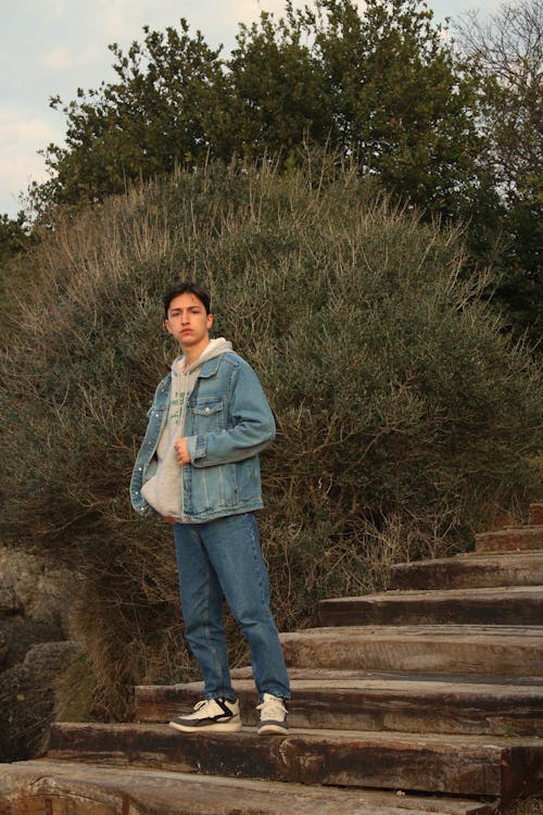 Young Man in a Casual Outfit Standing on Steps 