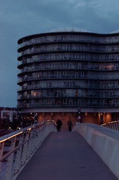Illuminated modern architecture in Copenhagen during twilight, showcasing urban design.