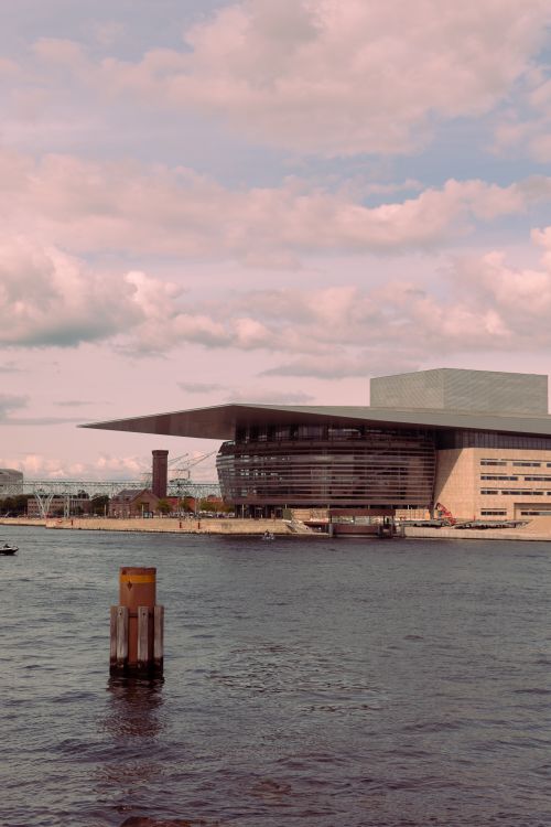 Free Scenic view of Copenhagen Opera House on a sunny day by the waterfront in Denmark. Stock Photo