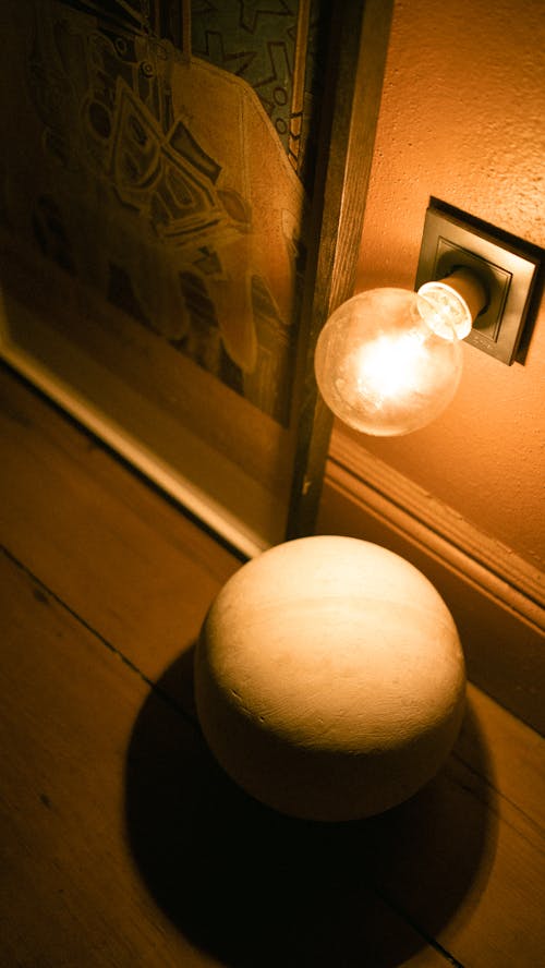 Photo of a Ball and a Glowing Bulb