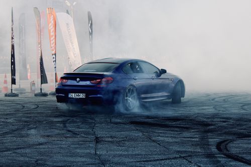 Free BMW M6 drifting at a smoky automotive event in Türkiye. Energetic and thrilling display. Stock Photo