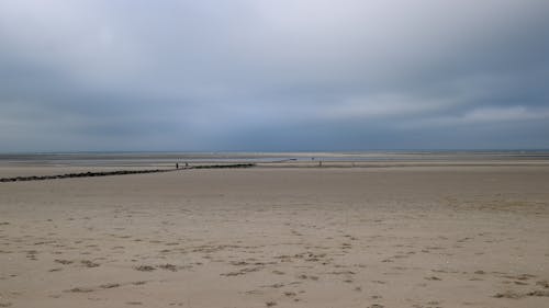 Sandy Beach under Rain Clouds