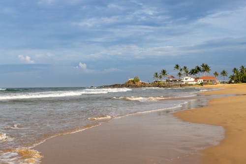 View of the Ahungalla Beach with a House and Palm Trees in Distance, Sri Lanka