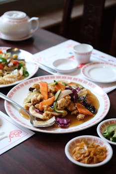 Delicious traditional Chinese dish with vegetables served on a restaurant table.
