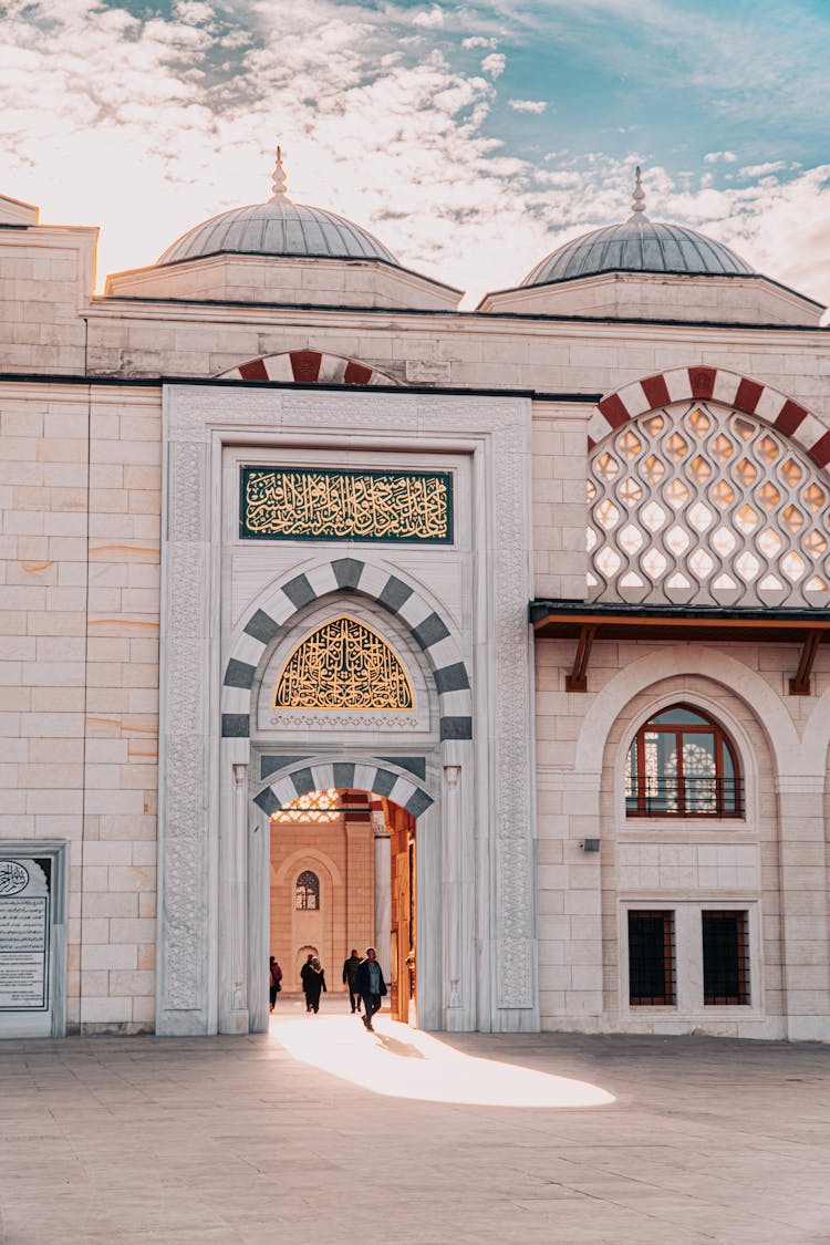 People Walking Outside Traditional Mosque