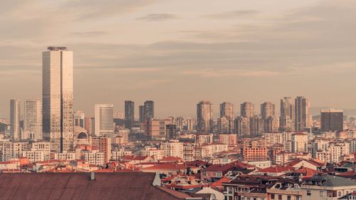 Free Aerial view of a city showcasing a skyline with modern skyscrapers under a calm sky. Stock Photo