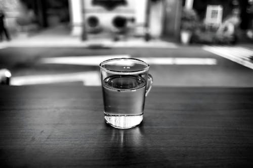 Gray Scale Photo of Glass With Water