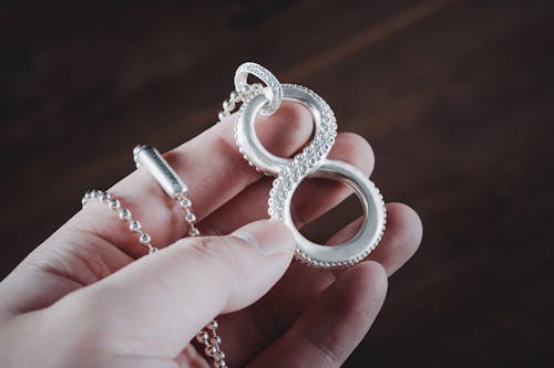 Woman Holding an Octopus Tentacle Pendant in her hand 