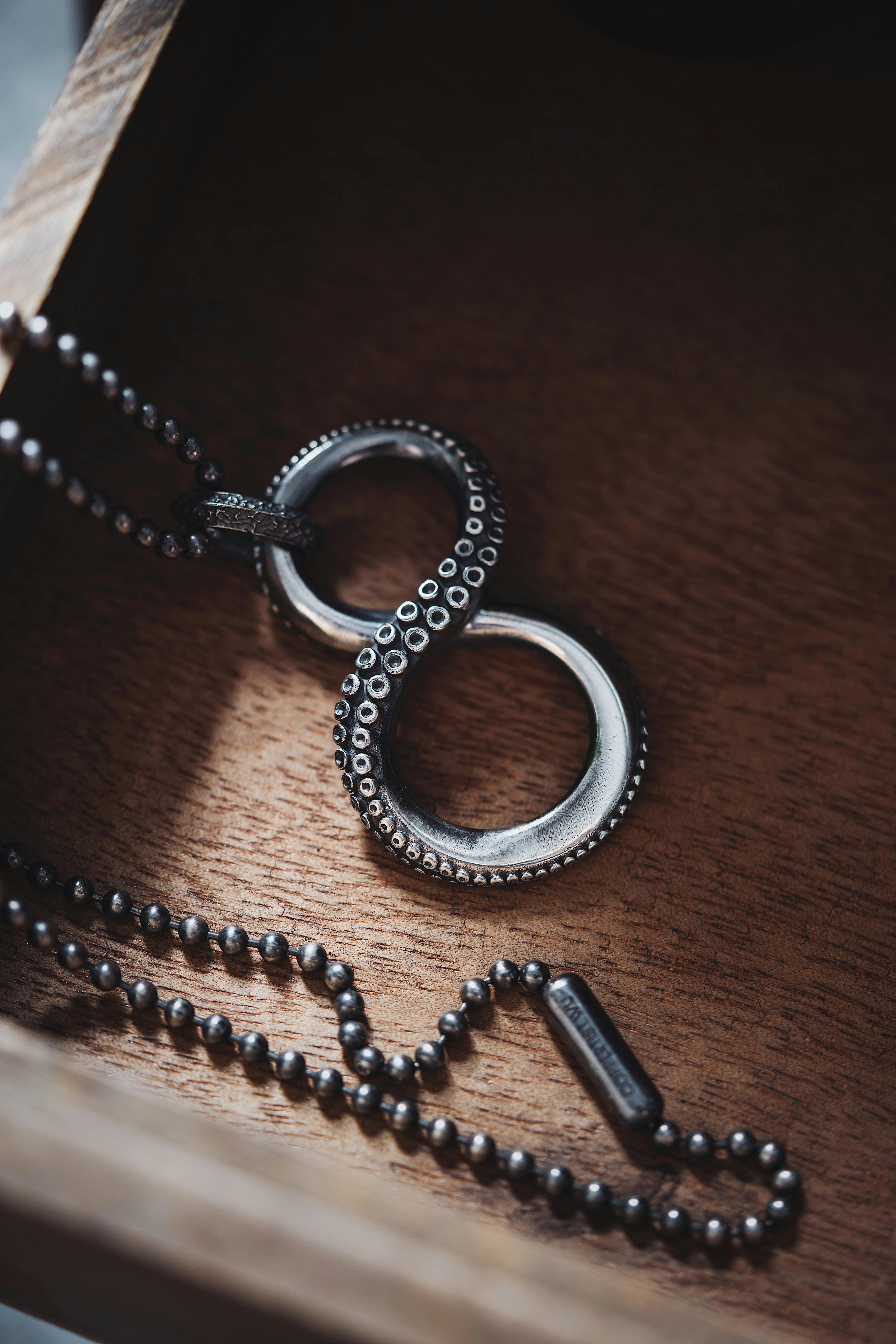 Close-up of Brass Octopus Tentacle Hooks on Black Background