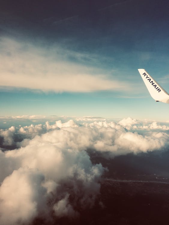 Plane's Tail Near Clouds
