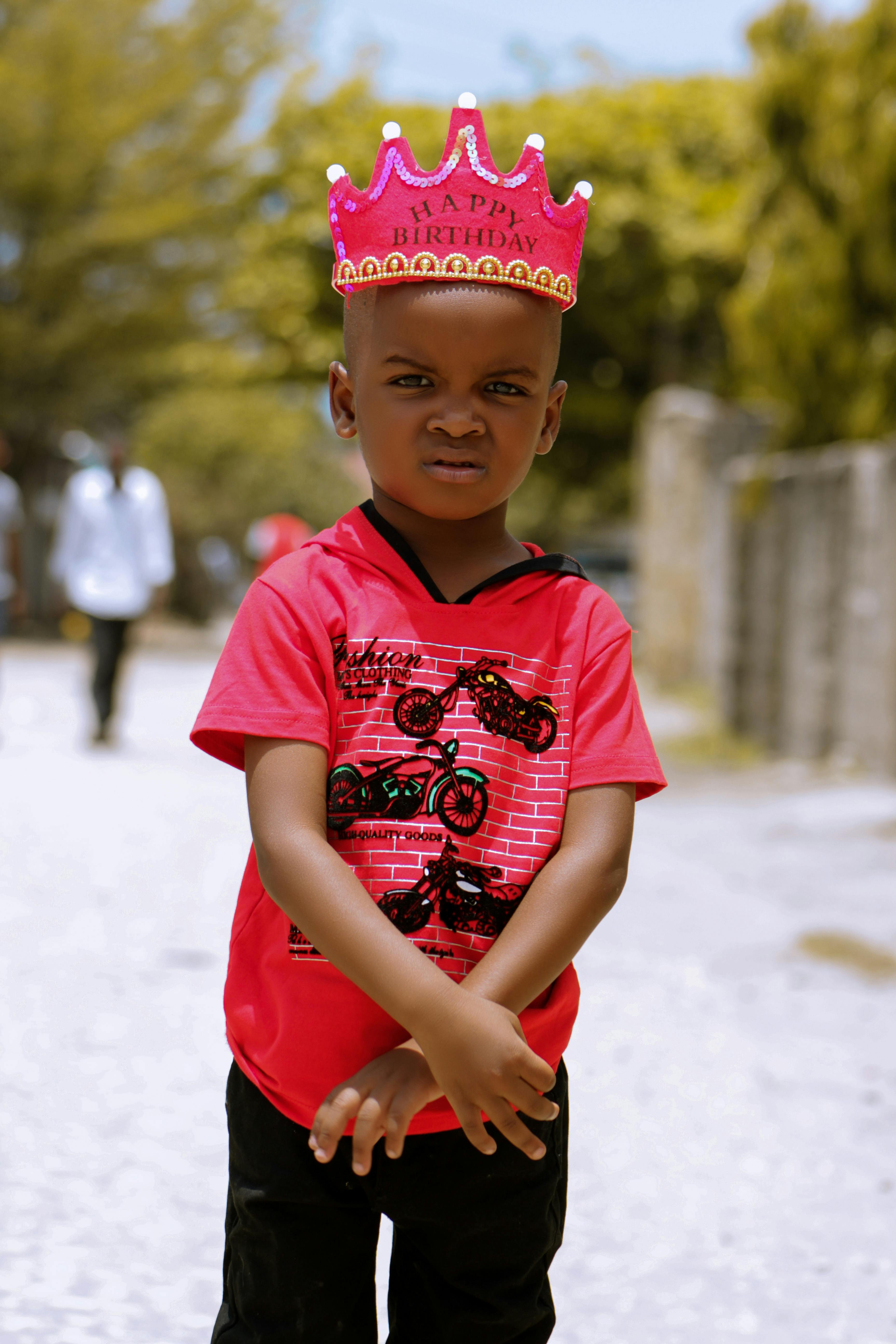 photo of boy wearing crown