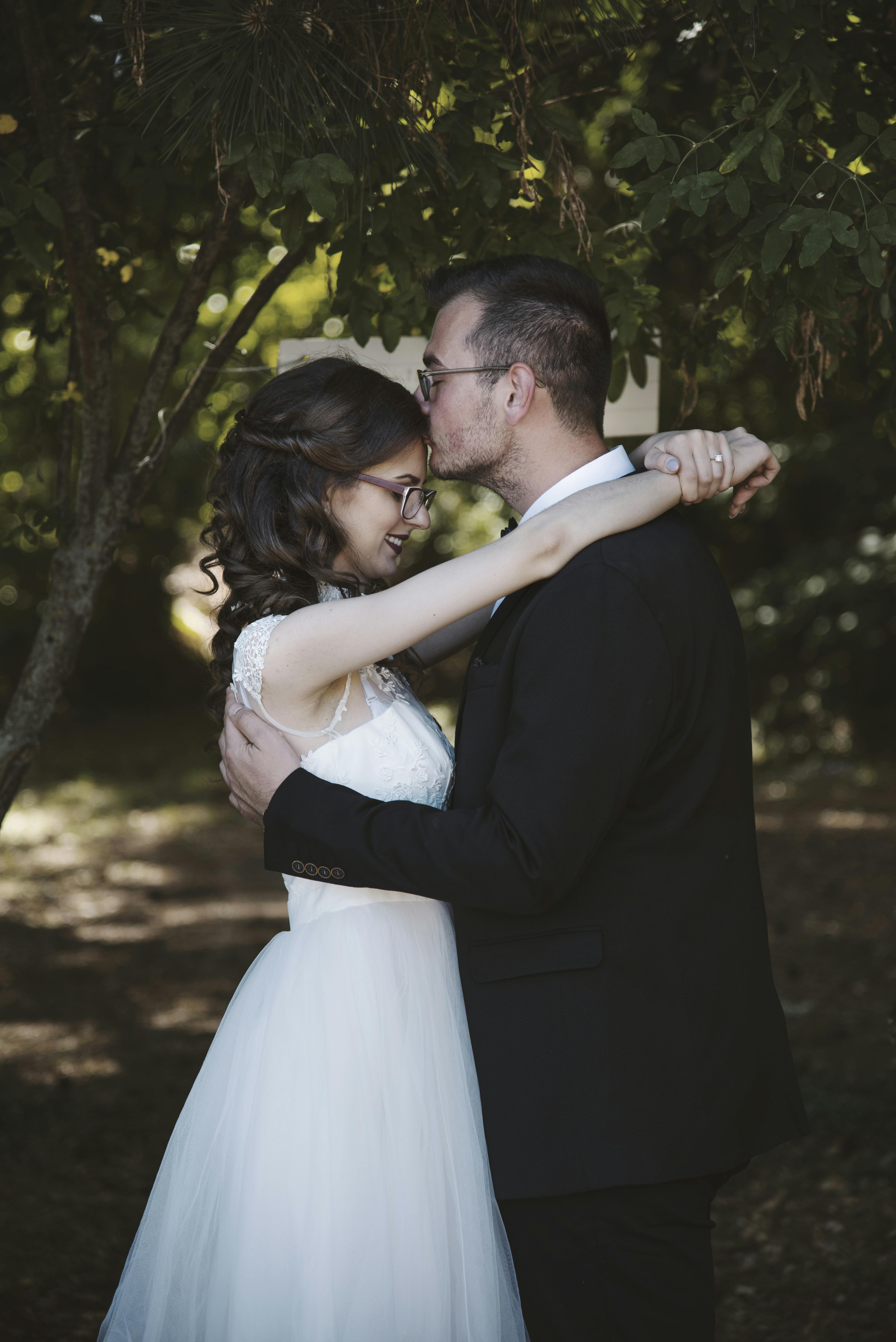 groom kissing bride on the forehead