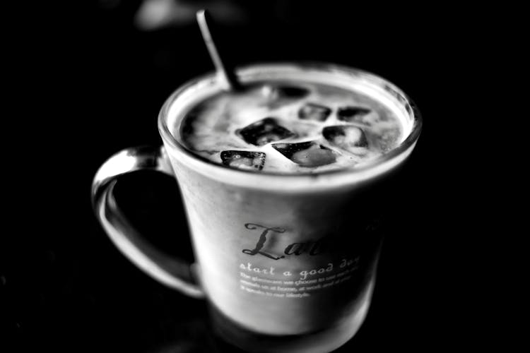 Grayscale Photo Of Cup With Ice Cubes