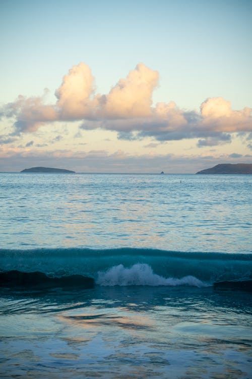 Waves Splashing on Seashore on Sunset