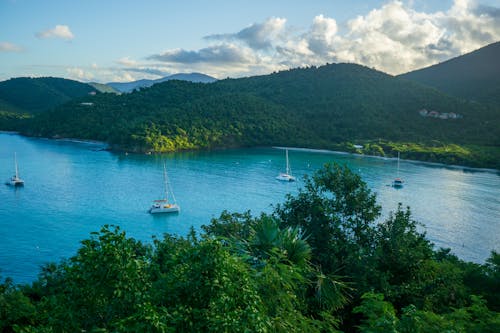 Boats Sailing in Water in Tropical Mountains Landscape