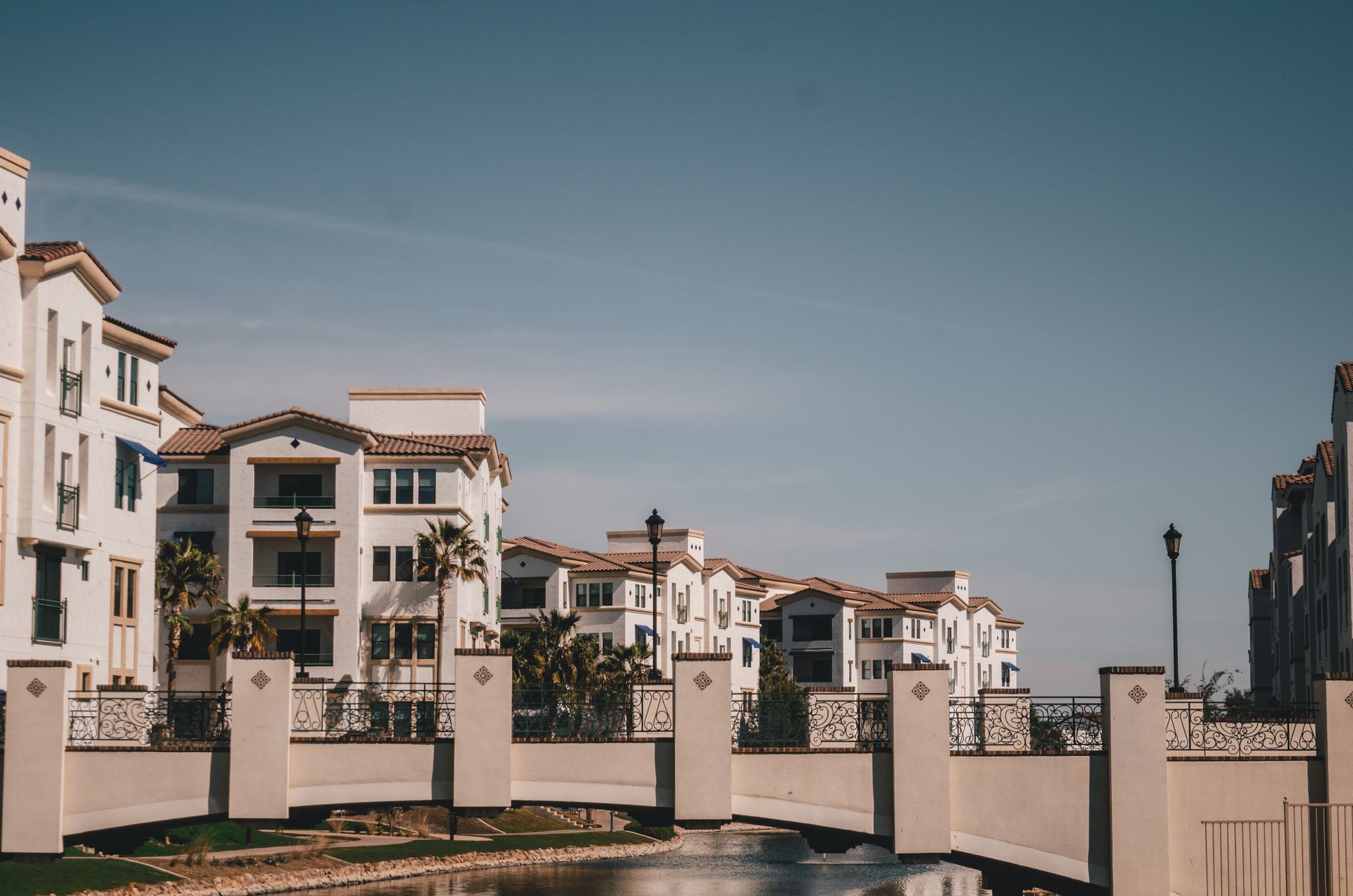 Charming residential district in Chandler, AZ featuring a bridge and canal on a sunny day.