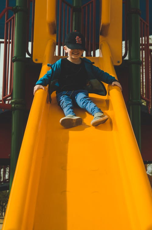 Happy Little Boy on Orang Slide