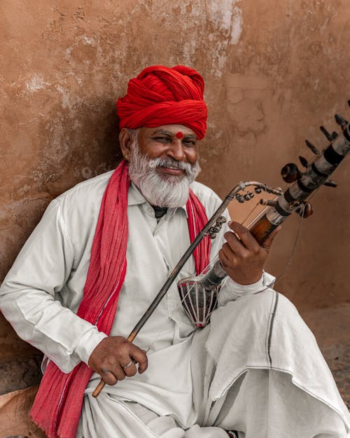 Man Sitting With Music Instrument in Hands