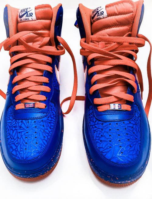 Free Close-up of vibrant blue and orange Nike Air Force 1 high-top sneakers. Stock Photo