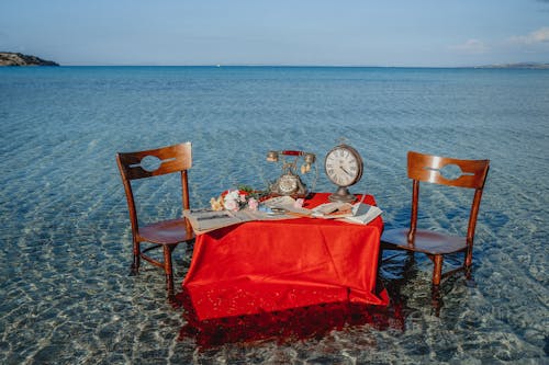Retro Items on Table with Chairs in Sea