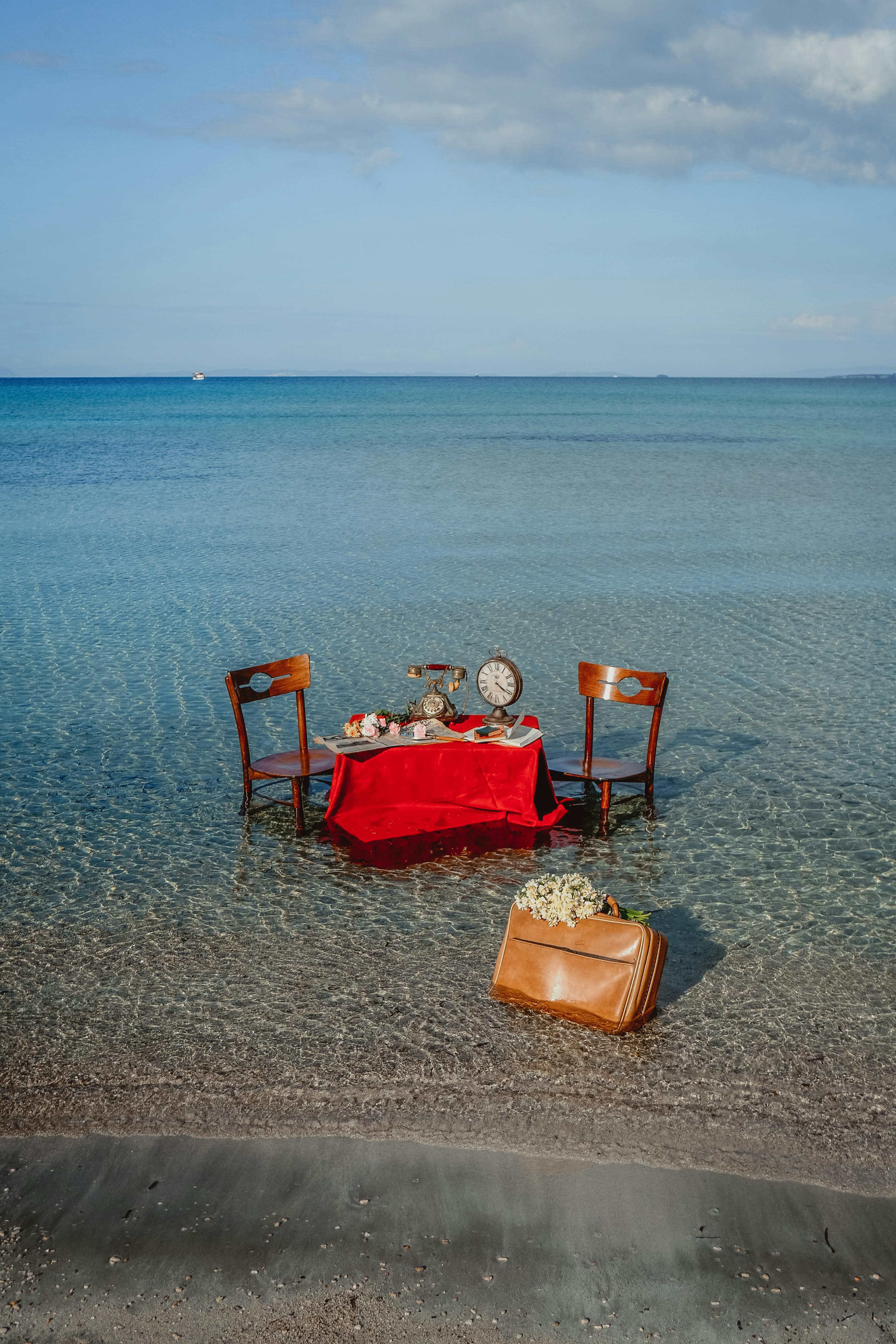 Table and Chairs in the Water on the Seashore · Free Stock Photo
