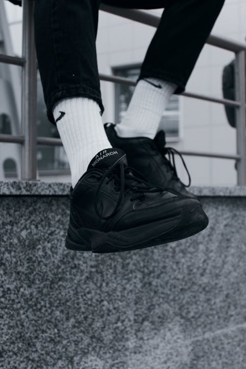 Close-up of Man Legs in Black Sneakers