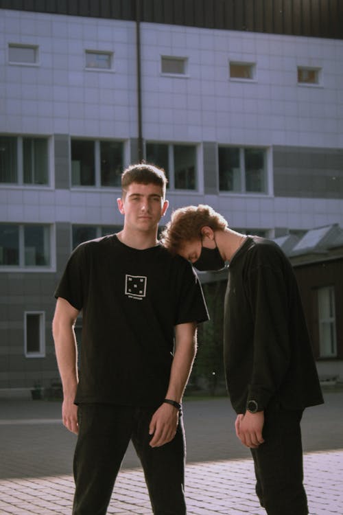 Men in Black Streetwear Posing Outdoors