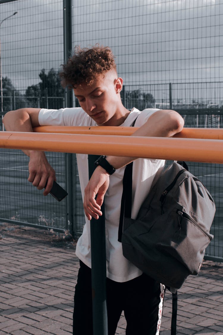 Man With Backpack Posing Near Sport Bars