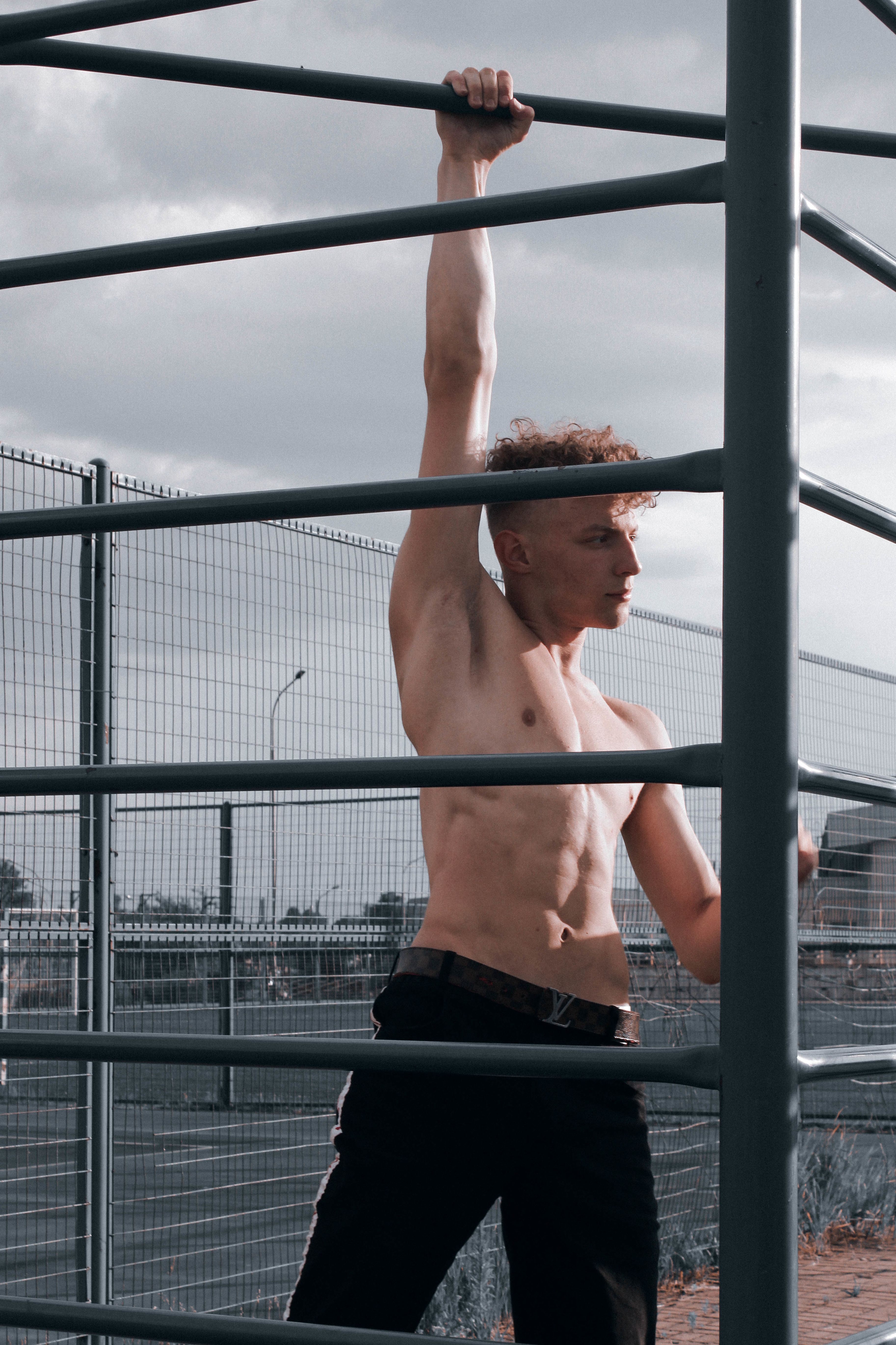 topless-man-training-on-sport-bars-on-stadium-free-stock-photo