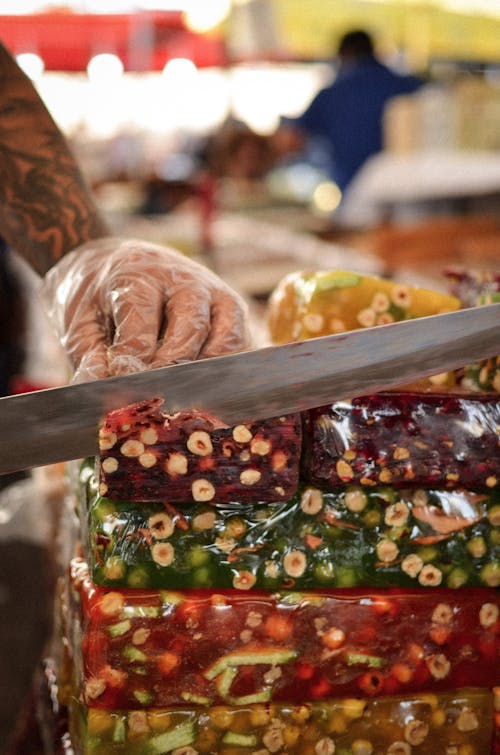 Hand in Glove Cutting Jelly at Market