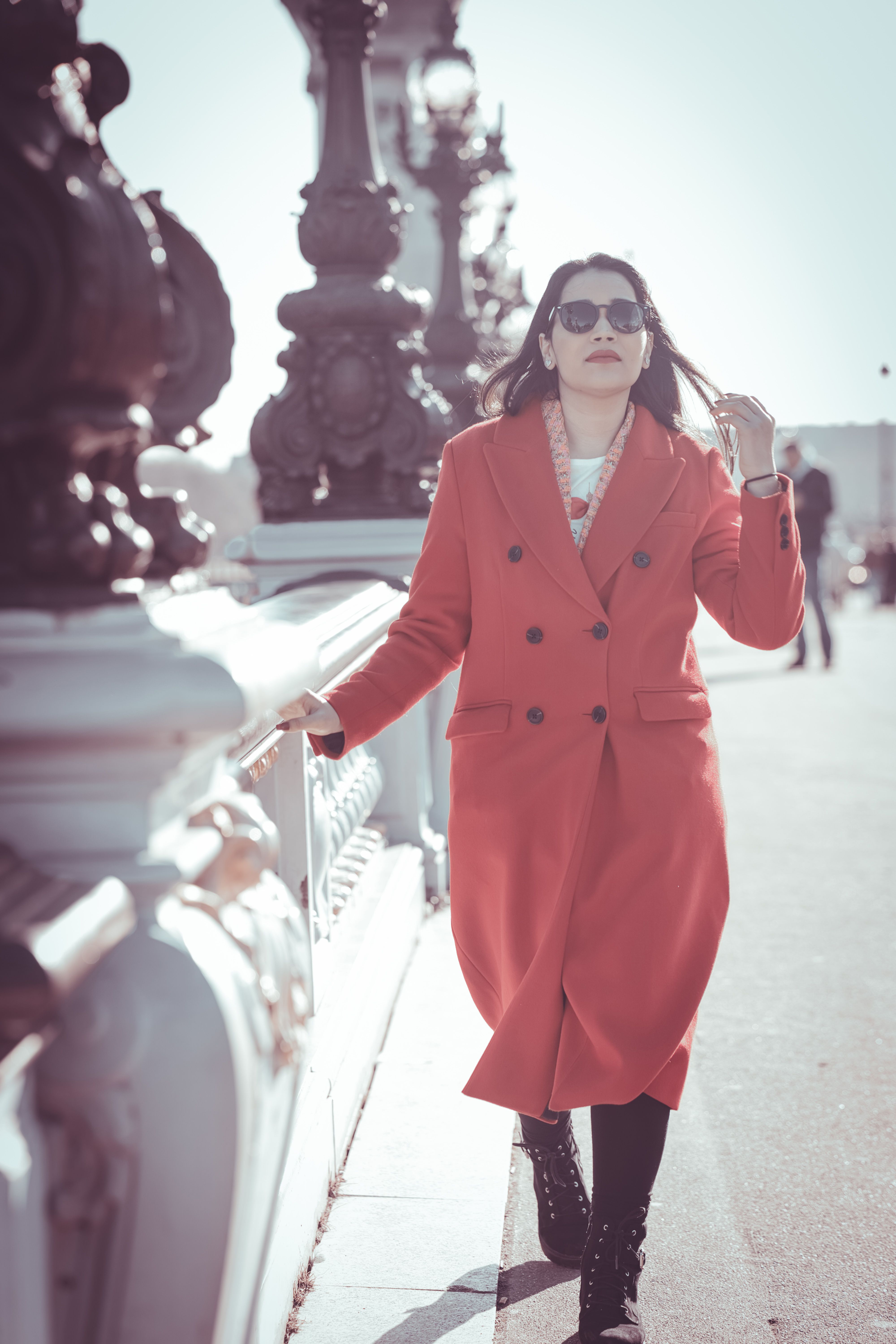 Woman in Coat and Sunglasses Walking on Bridge · Free Stock Photo