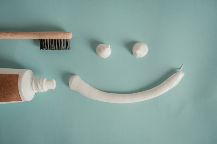 Toothbrush, A A Tube Of Toothpaste And A Smile Painted With Toothpaste