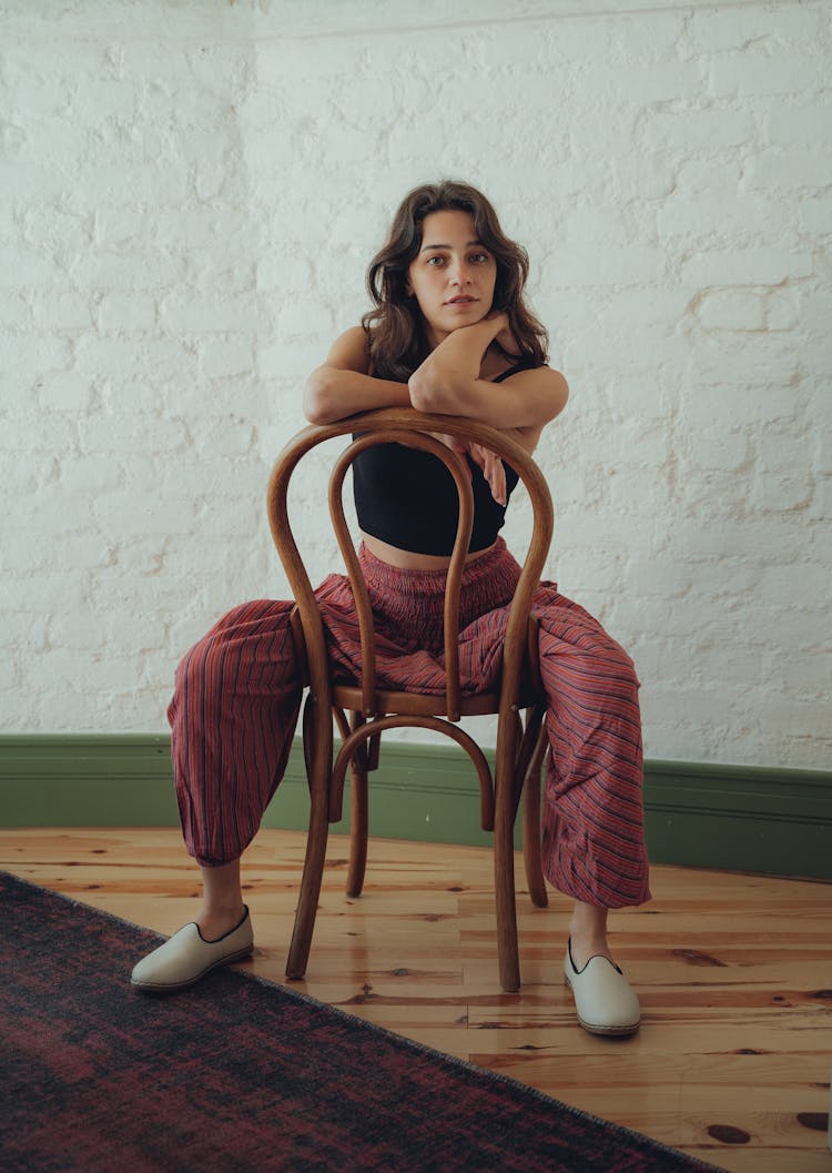 Young Woman Sitting On A Chair