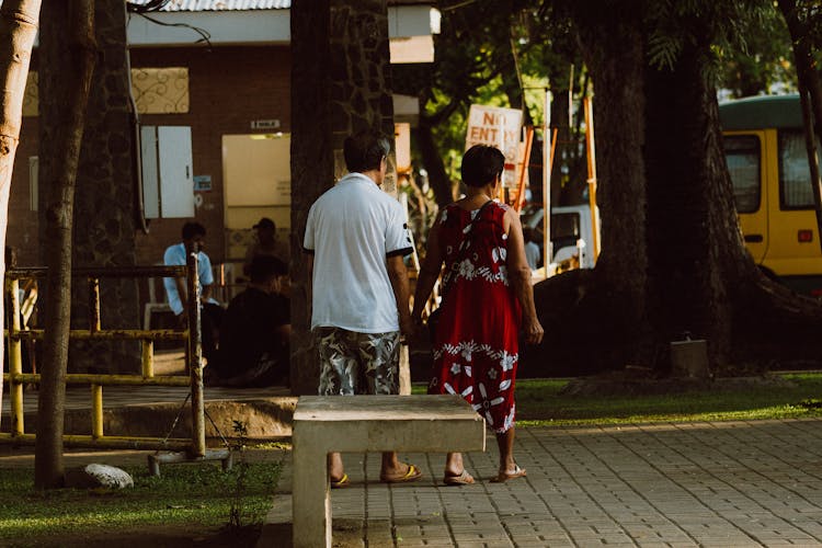 Couple Walking And Holding Hands In City