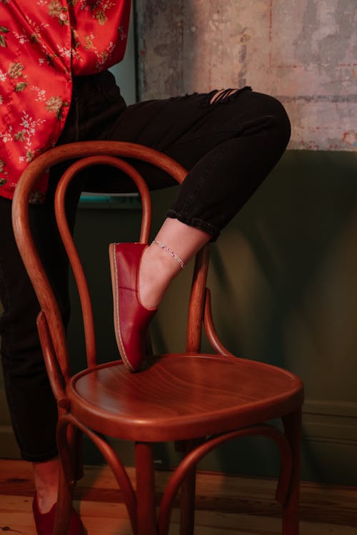 Person Holding Leg on Chair