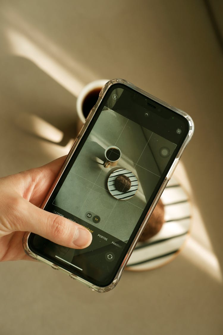 Woman Taking Photo Of A Mug Of Coffee With A Smart Phone