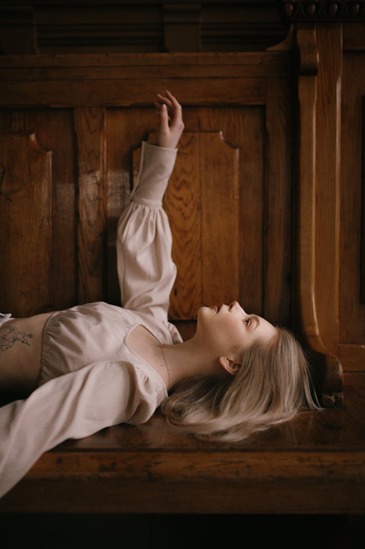 Blonde Lying On Vintage Wooden Bench