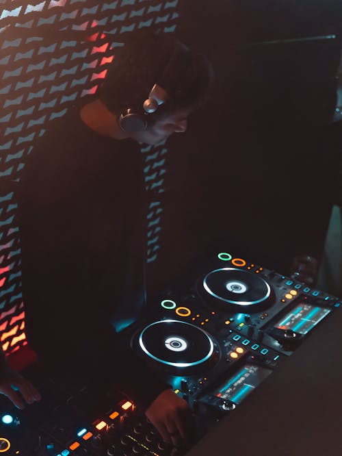 Disc Jockey Mixing Music in a Nightclub